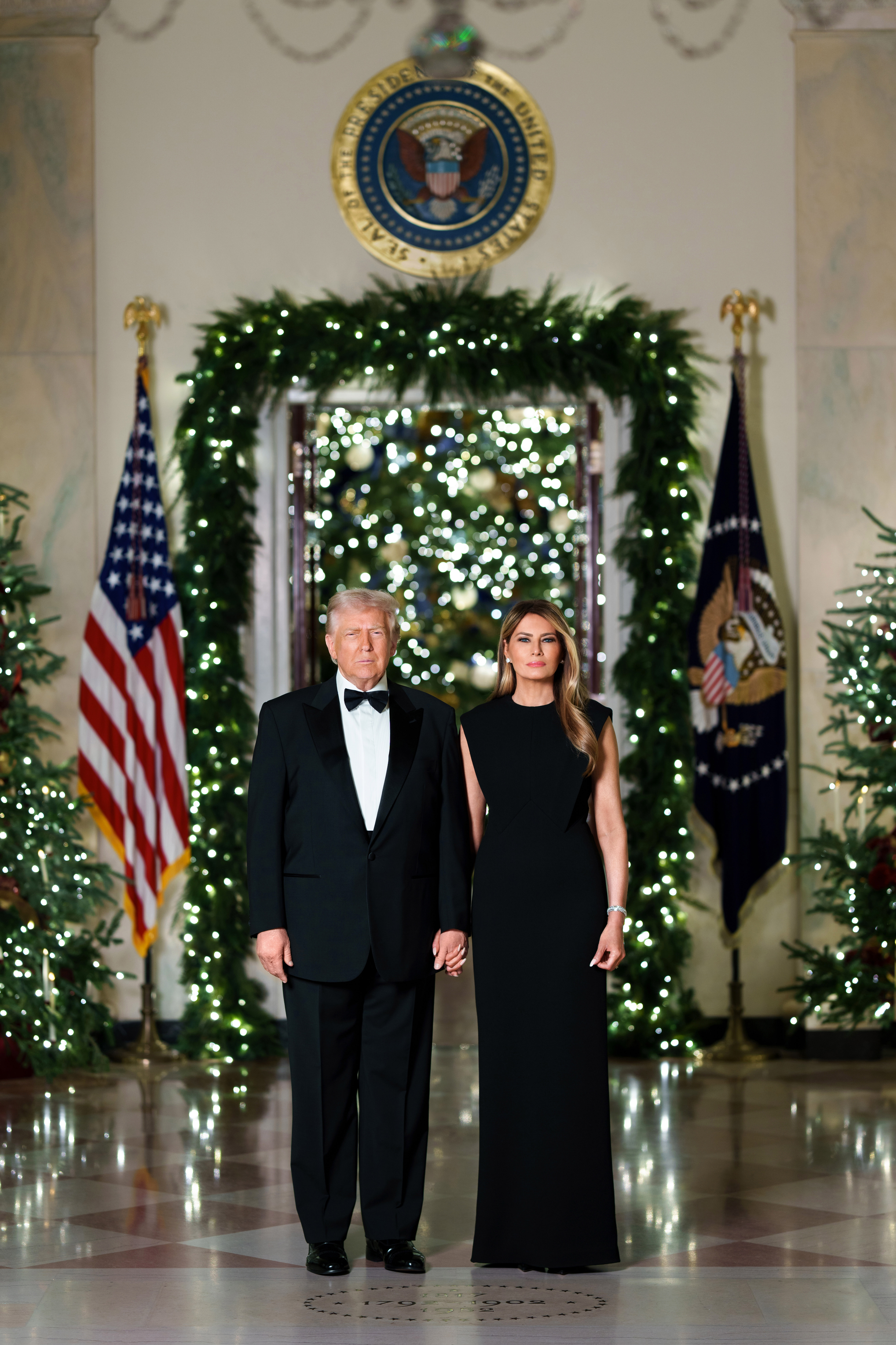 President Donald Trump and First Lady Melania Trump pose for an official Christmas portrait, Sunday, December 7, 2025 in the Cross Hall at the White House. (Official White House Photo by Andrea Hanks)